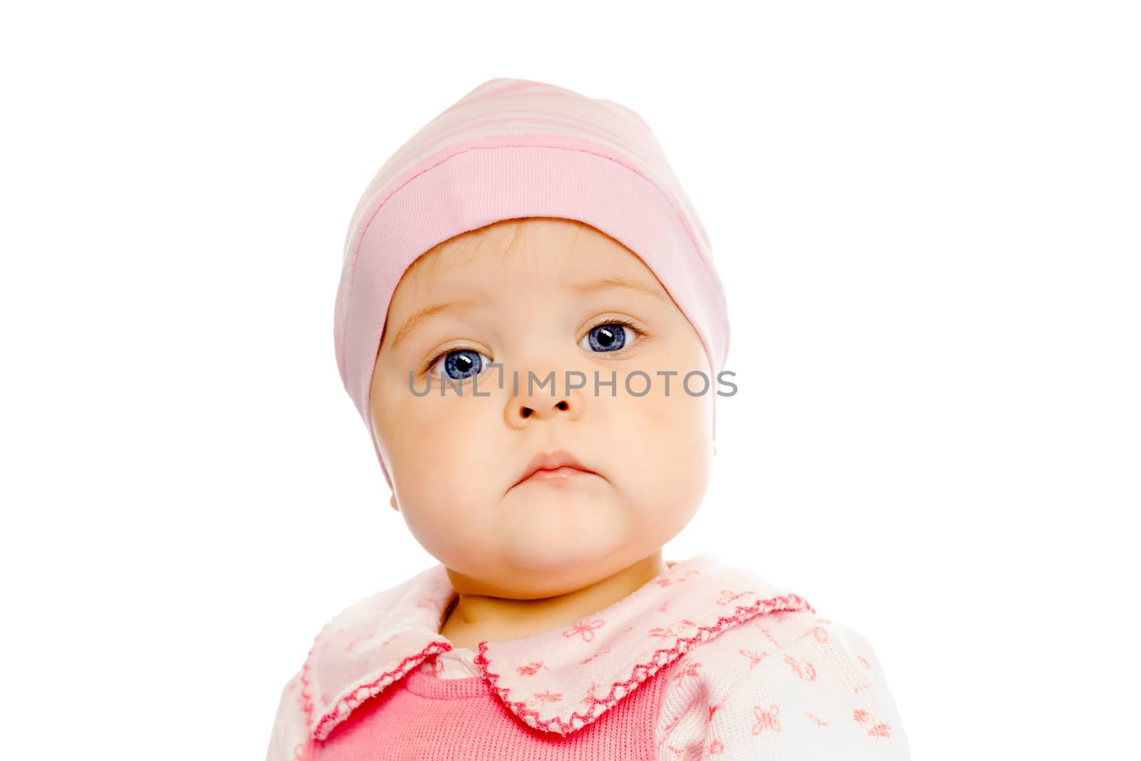 Portrait of a serious baby in a pink hat on a white background