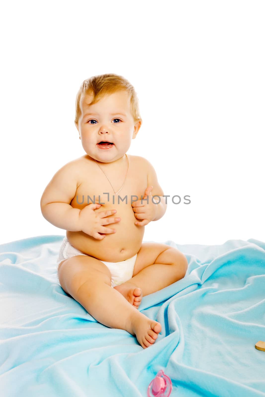 baby in diaper sitting on a blue blanket. Isolated by pzRomashka