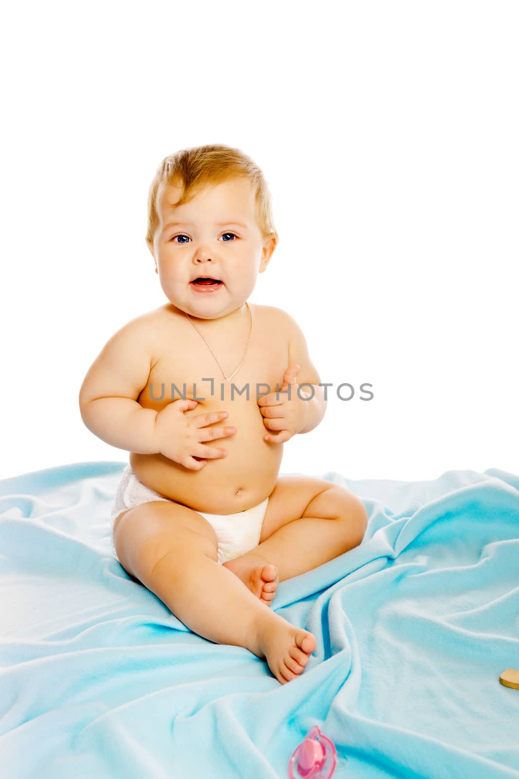 baby in diaper sitting on a blue blanket. Studio. Isolated