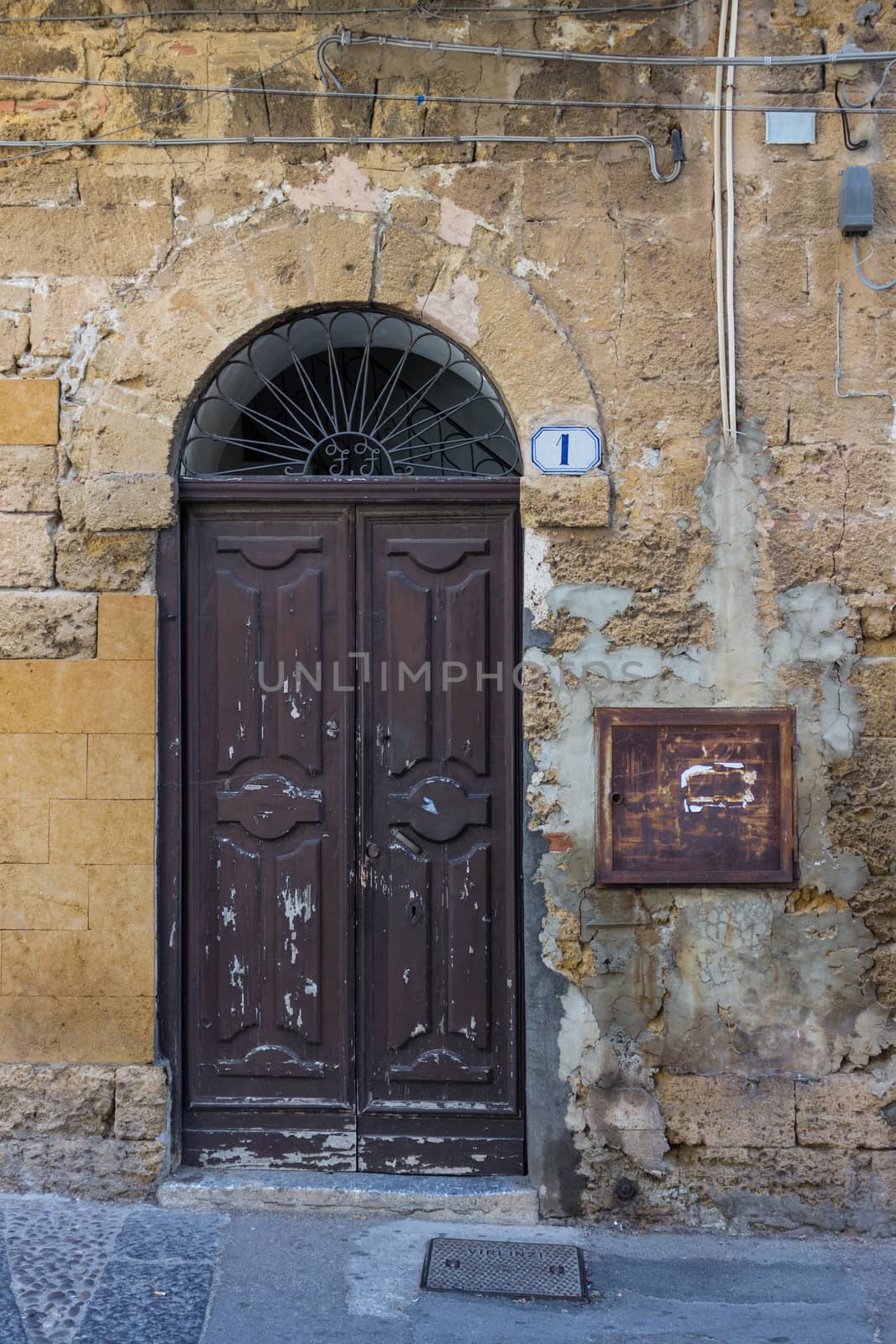 An old brown wooden door in the provence.