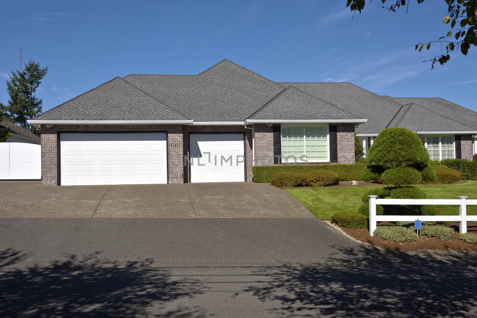 Large home with white fences and manicured lawn Oregon.