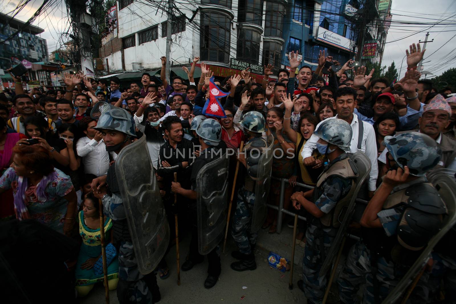NEPAL, Kathmandu: After years of debate, Nepal adopted a new constitution on September 20, 2015, prompting scores of residents to celebrate near the constituent assembly building in Kathmandu. Out of the 598 members of the Constituent Assembly, 507 voted for the new constitution, 25 voted against, and 66 abstained in a vote on September 16, 2015. The event was marked with fireworks and fesitivities, but also with protests organized by parties of the Tharu and Madhesi ethnic communities.