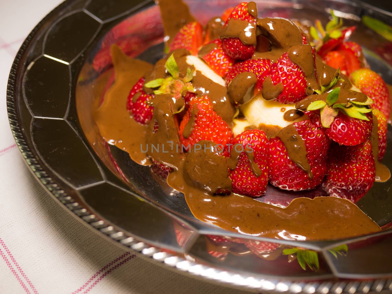 strawberry with hot chocolate on silver plate