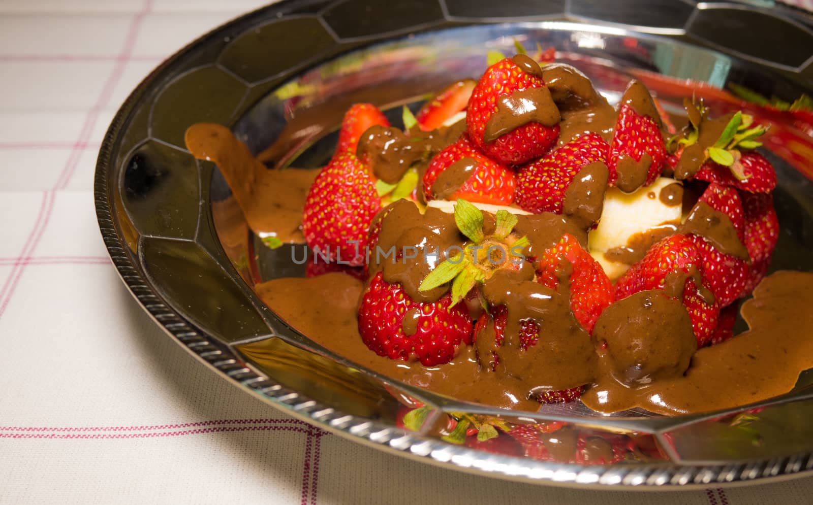 strawberry with hot chocolate on silver plate
