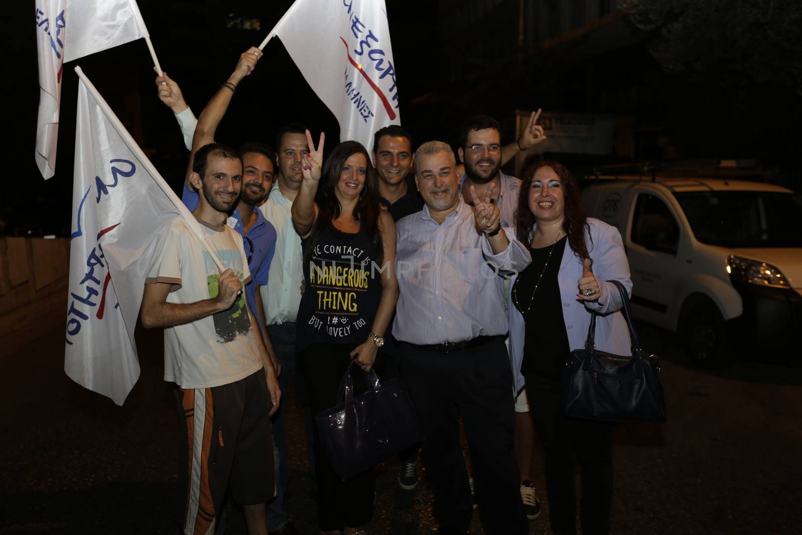 GREECE, Athens: Independent Greeks supporters pose with party flags in Athens after their party agreed to enter a coalition agreement with victorious Syriza after Greece's parliamentary election on September 20, 2015.
