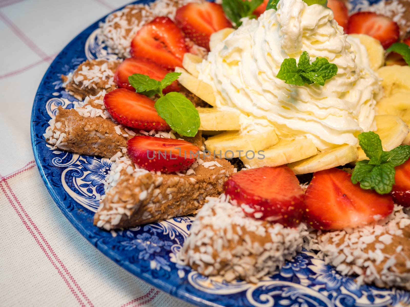 Chocolate dessert with banana and strawberry under whipped cream by dolfinvik