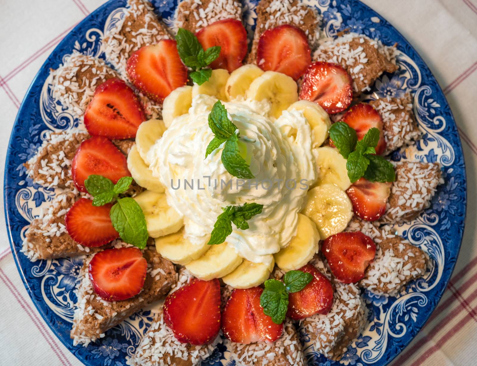 Chocolate dessert with banana and strawberry under whipped cream by dolfinvik