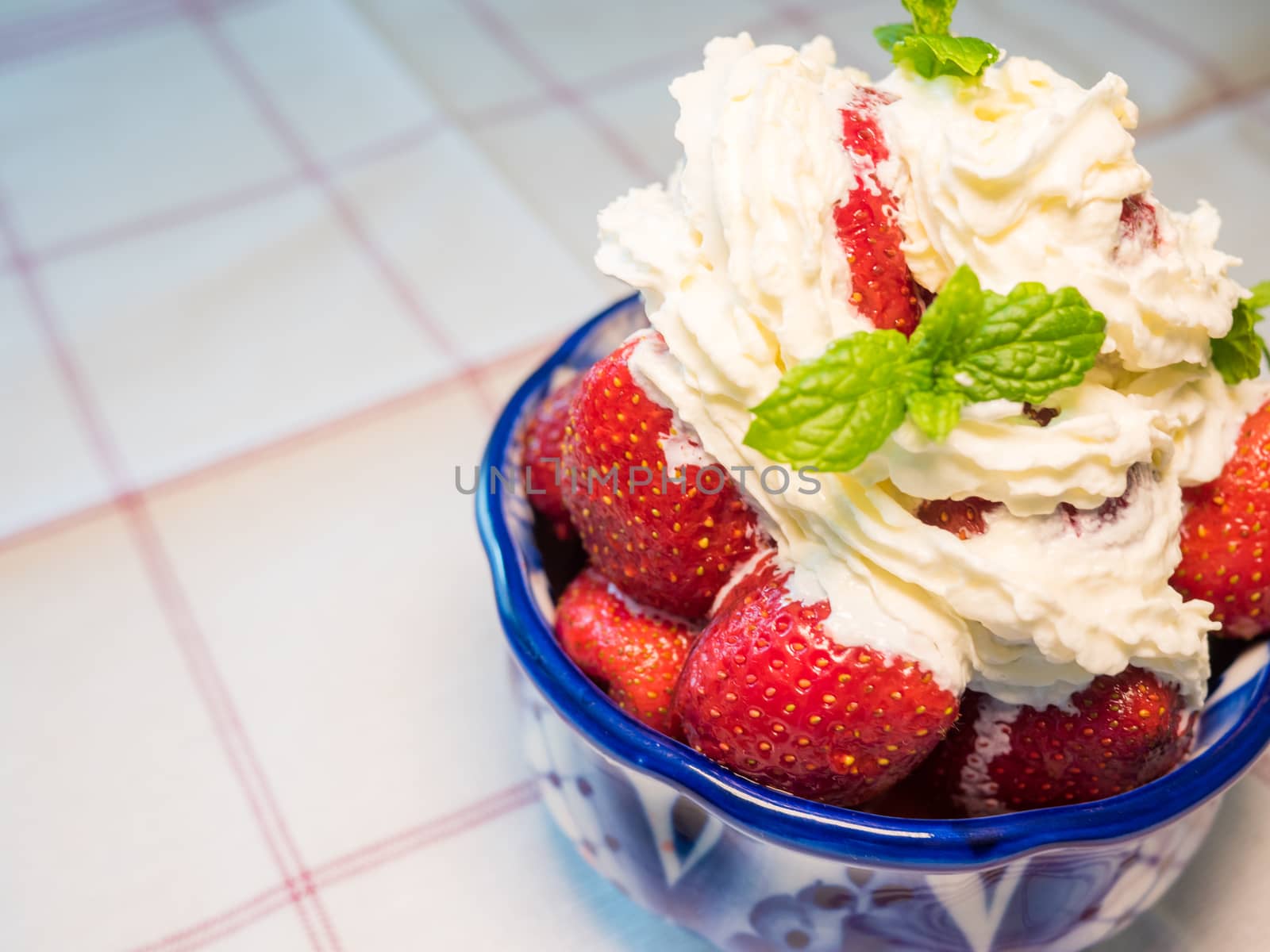Strawberry wuth whipped cream in traditional russian plate - gzhel