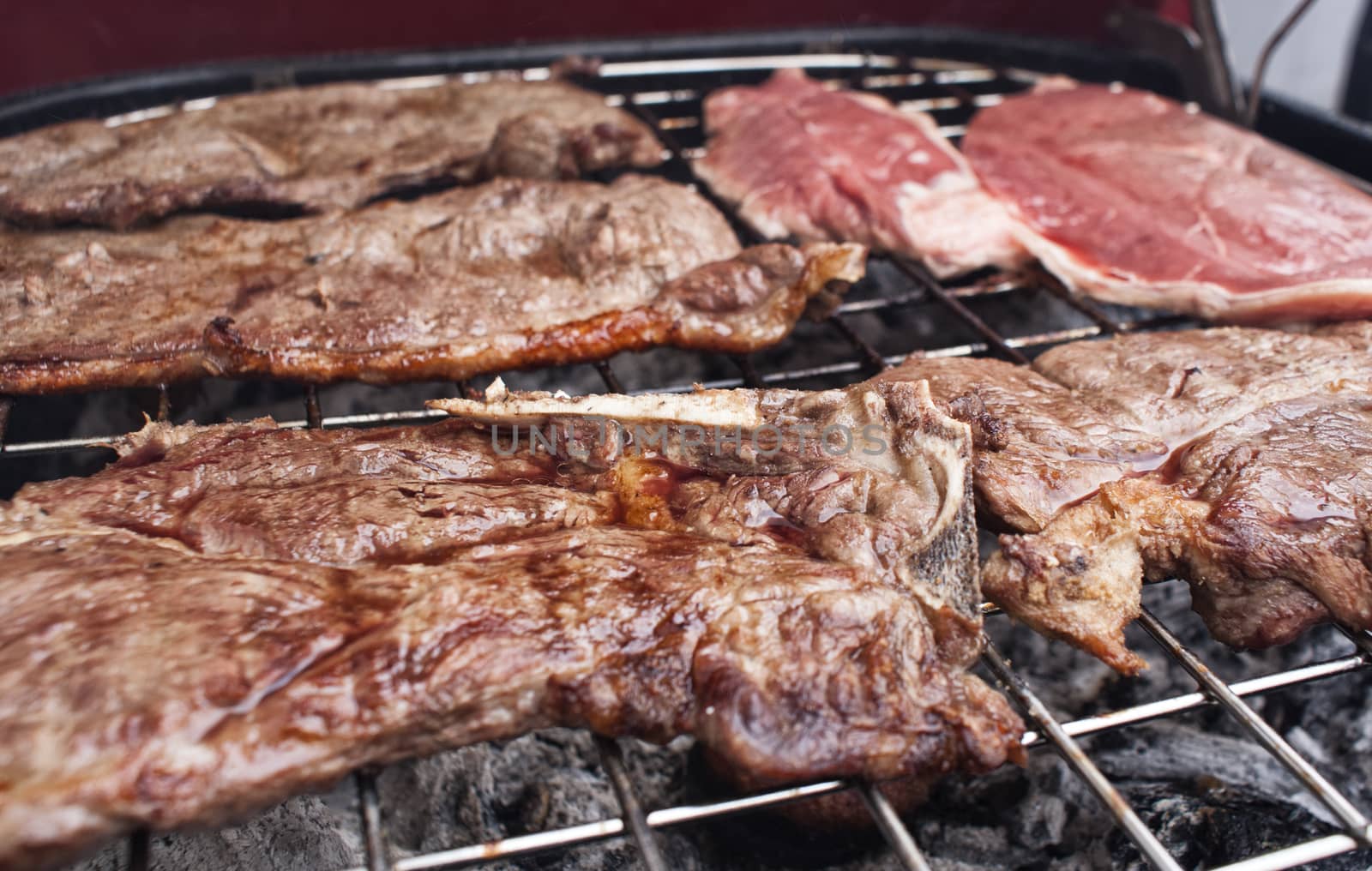 Photograph of some grilled meat juicy steaks