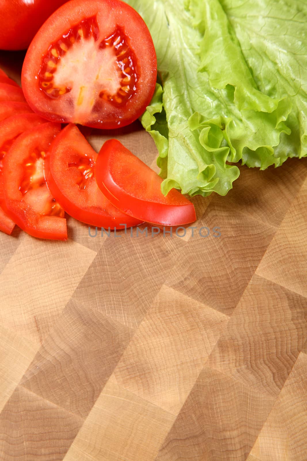 tomato and salad on a chopping board by sveter