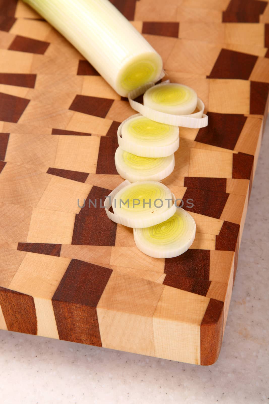 the leek cut by segments on a chopping board