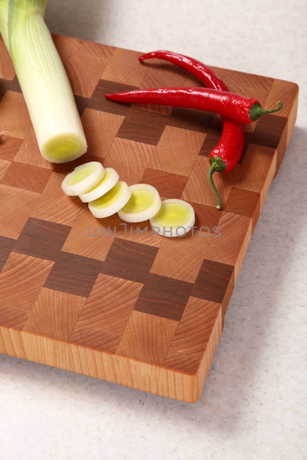 leek and chili pepper on a chopping board