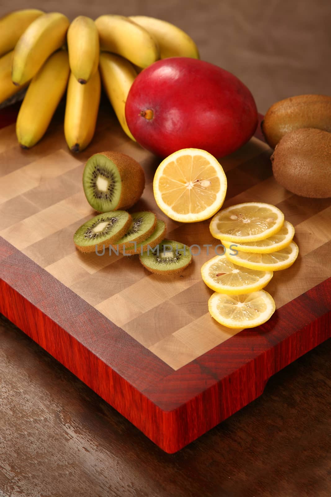 tropical fruit cut by segments on a chopping board