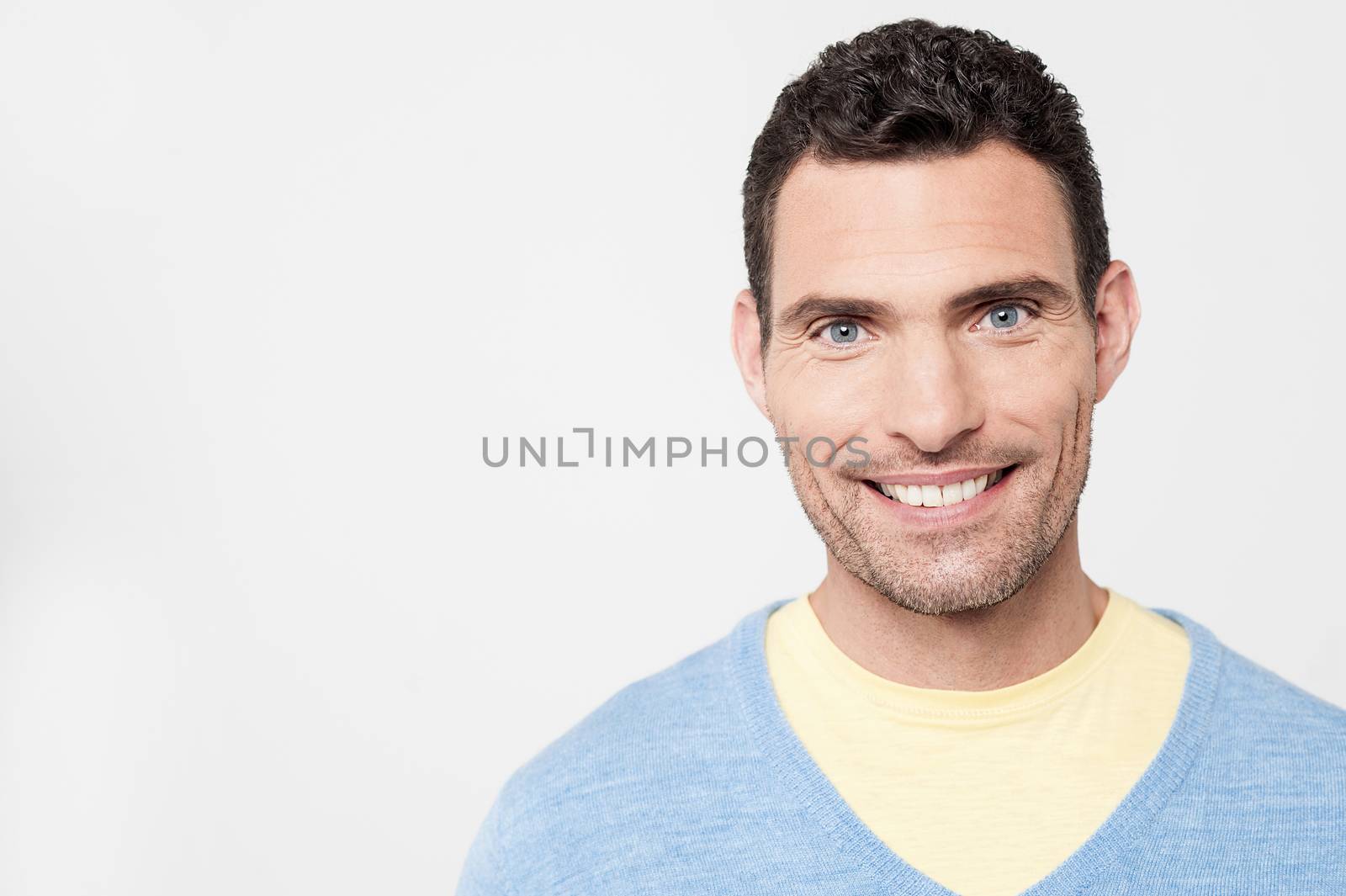 Smiling man posing over grey background