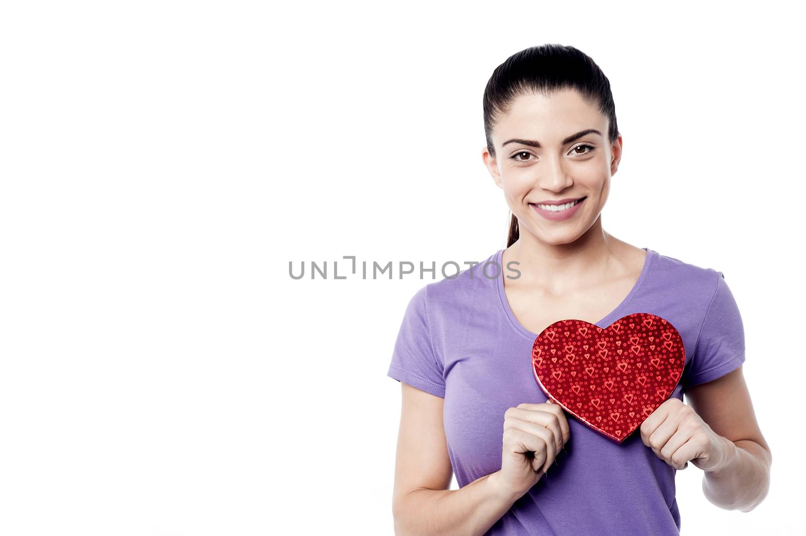 Pretty woman holding heart shape gift box