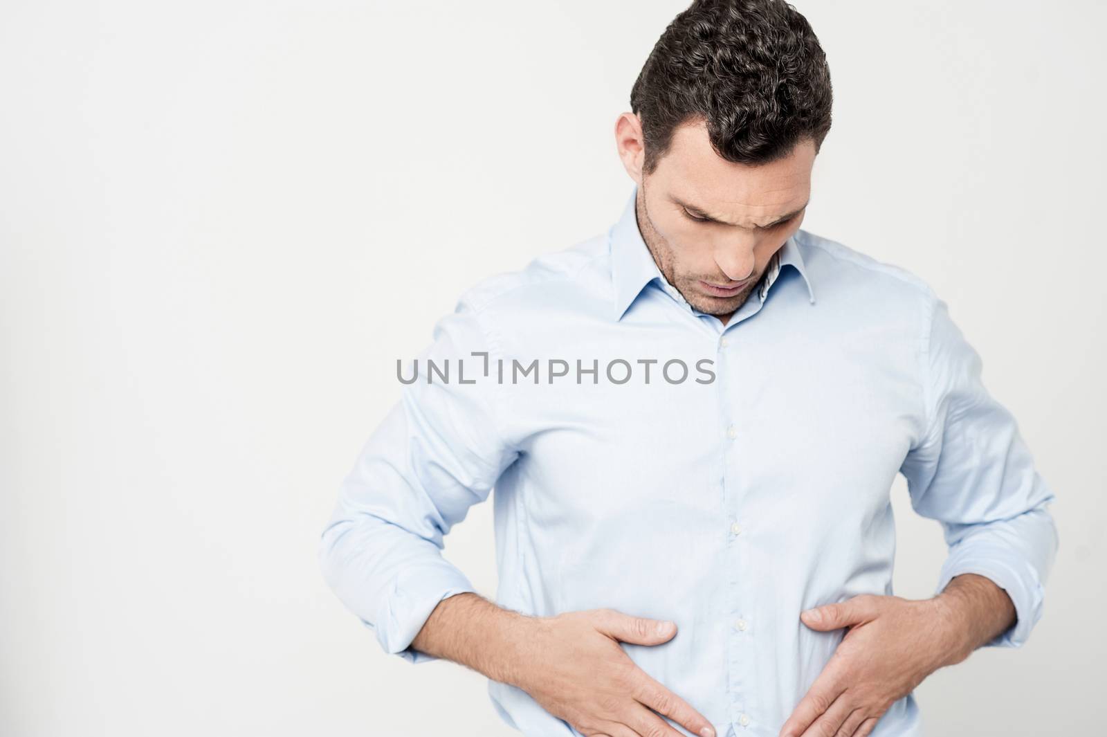 Man with strong stomach pain by stockyimages