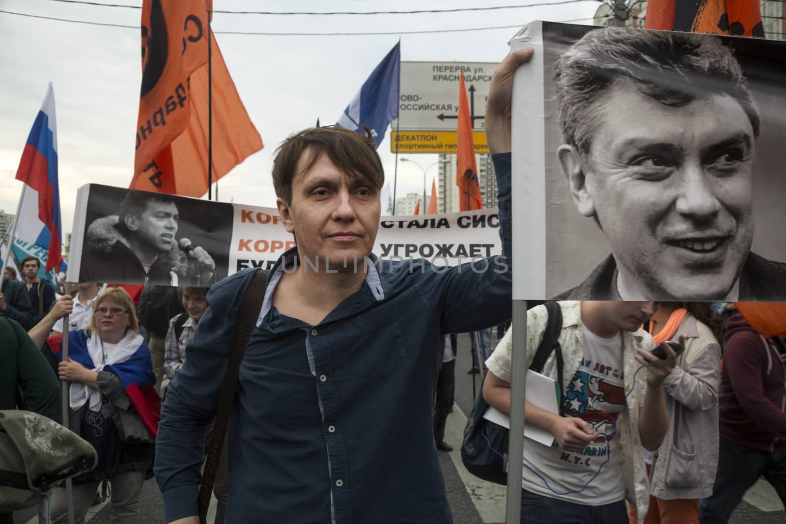 RUSSIA, Moscow: A man holds a photo of slain opposition politician Boris Nemstov as Russian opposition activists rallied in Moscow on September 20, 2015, in the wake of regional elections that widely favored the ruling United Russia party and prompted accusations of vote rigging. The Meeting to Change Power protest, organised by prominent anti-corruption campaigner Alexei Navalny, drew an estimated 2,000-4,000 people, well short of estimates in advance of the rally. 