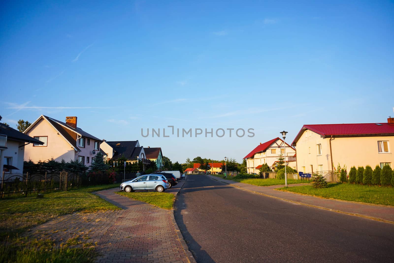 SIANOZETY, POLAND - JULY 18, 2015: Street with houses and parked cars
