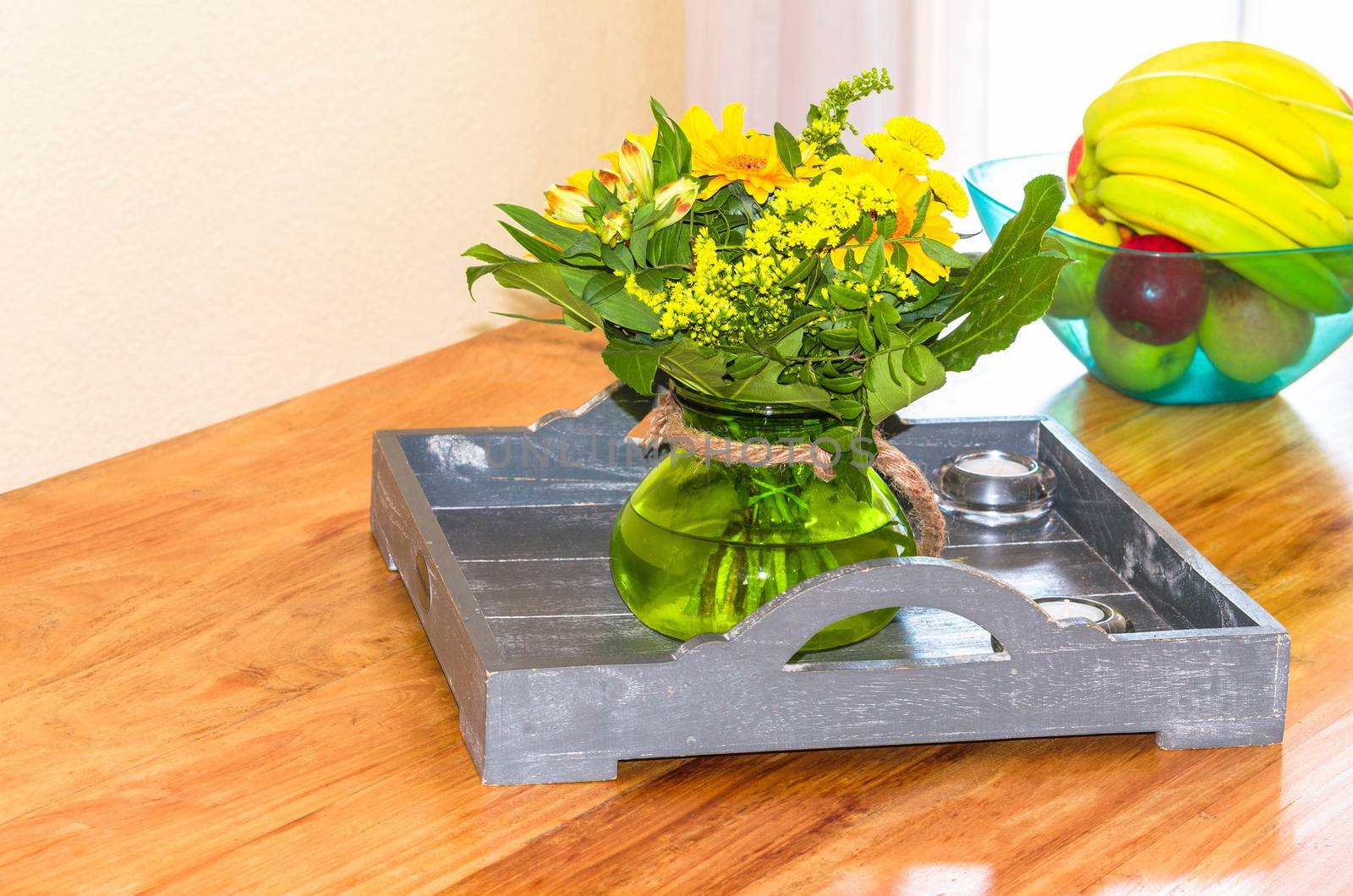 Decorative floral arrangement with assorted flowers on a table.