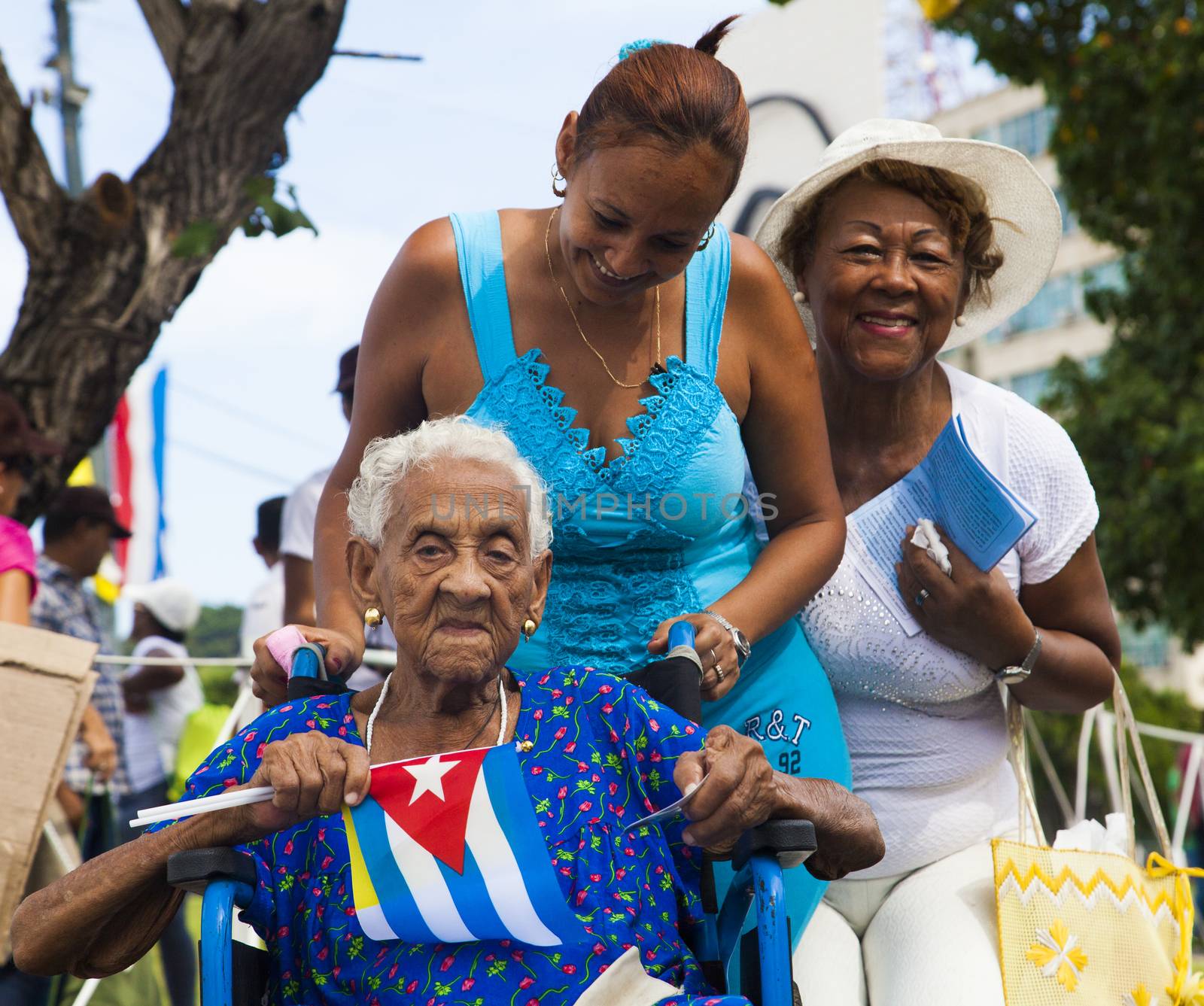 CUBA, Havana: Cuban women are pictured as Pope Francis celebrates mass in Revolution Square, in Havana, on September 20, 2015. Pope Francis is on the first full day of his three day visit to Cuba, where he meets President Raul Castro and Fidel Castro and hold Mass in Revolution Square before travelling to Holguin, Santiago de Cuba and El Cobre, then onwards to the United States.