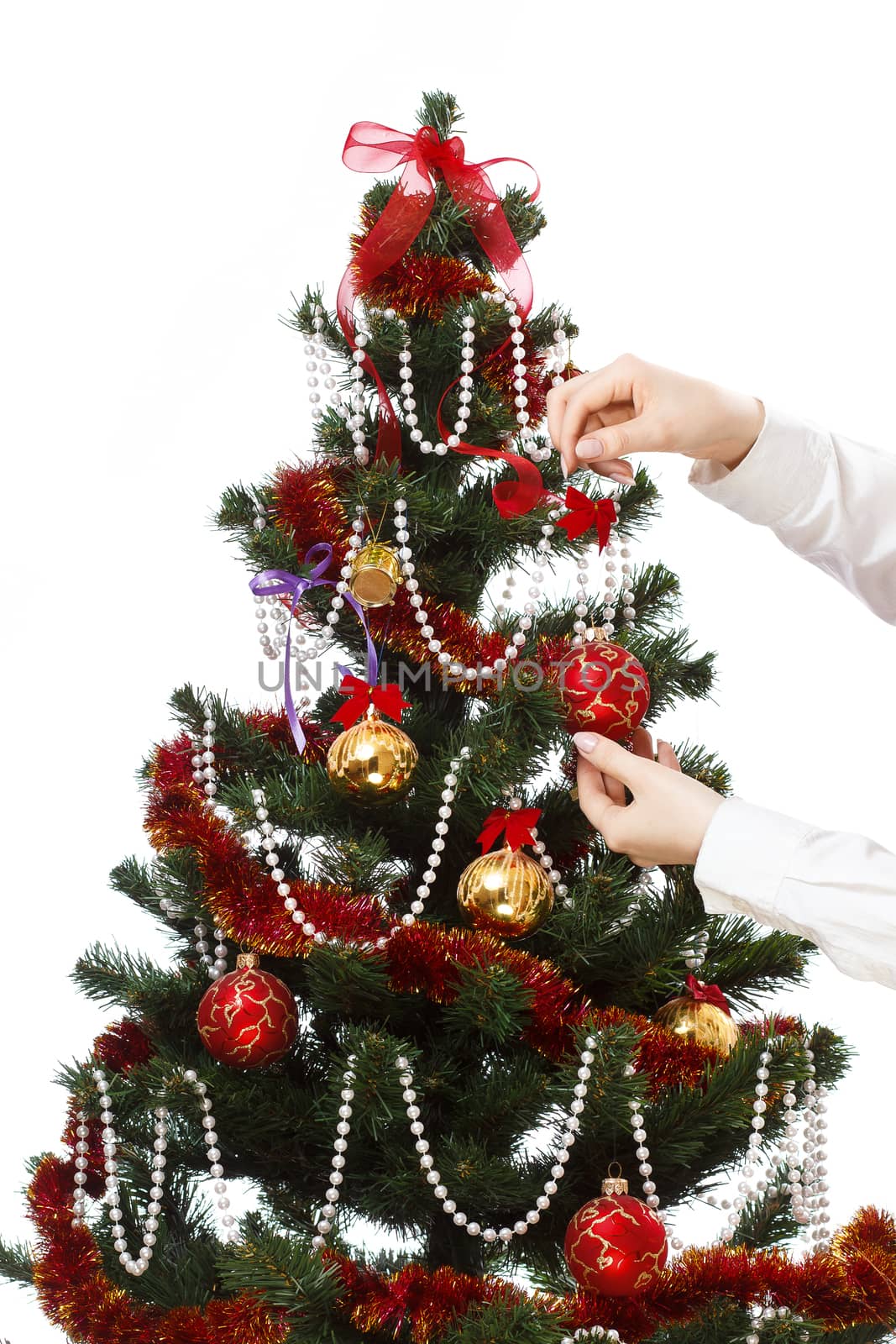 Decorating christmas tree with balls, ribbons and stuff, isolated on white background