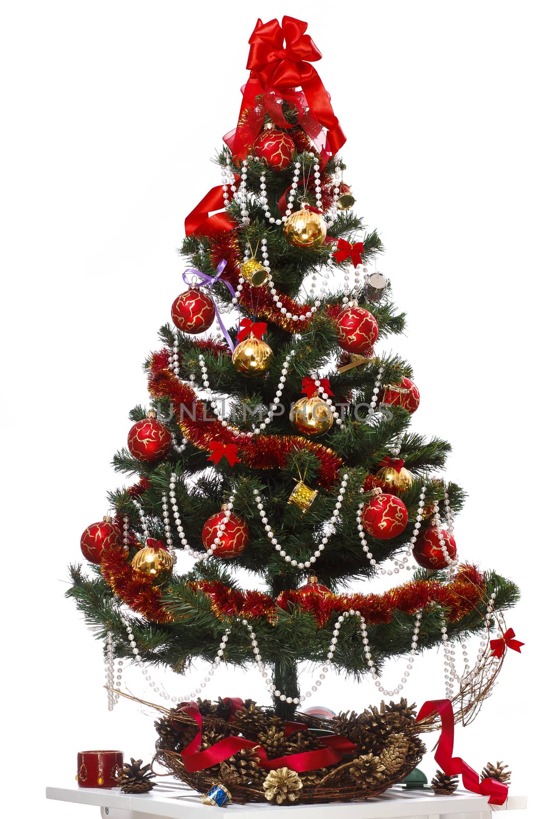 Decorating christmas tree with balls, ribbons and stuff, isolated on white background