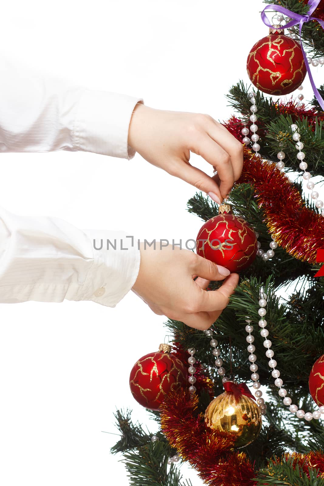 Decorating christmas tree with balls, ribbons and stuff, isolated on white background