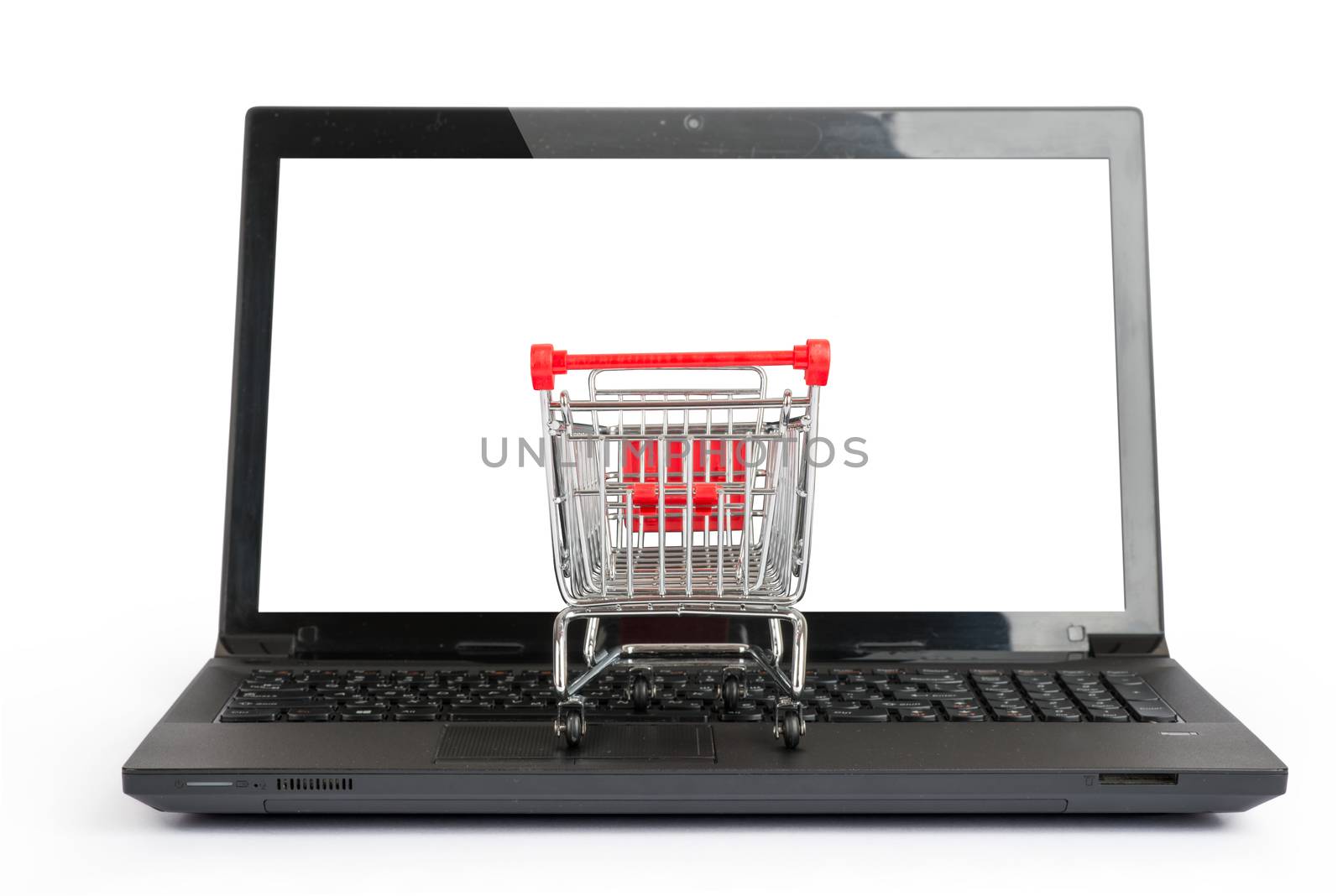 Small shopping cart on laptop, close  up view by cherezoff