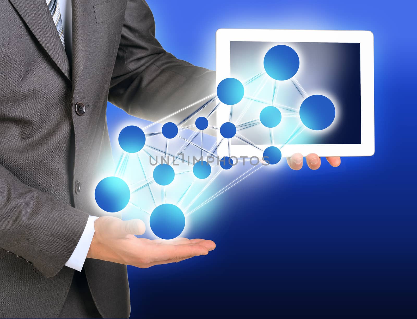 Businessman using tablet on abstract blue background