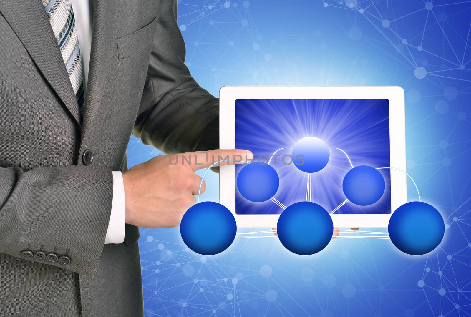 Businessman holding tablet on abstract blue background