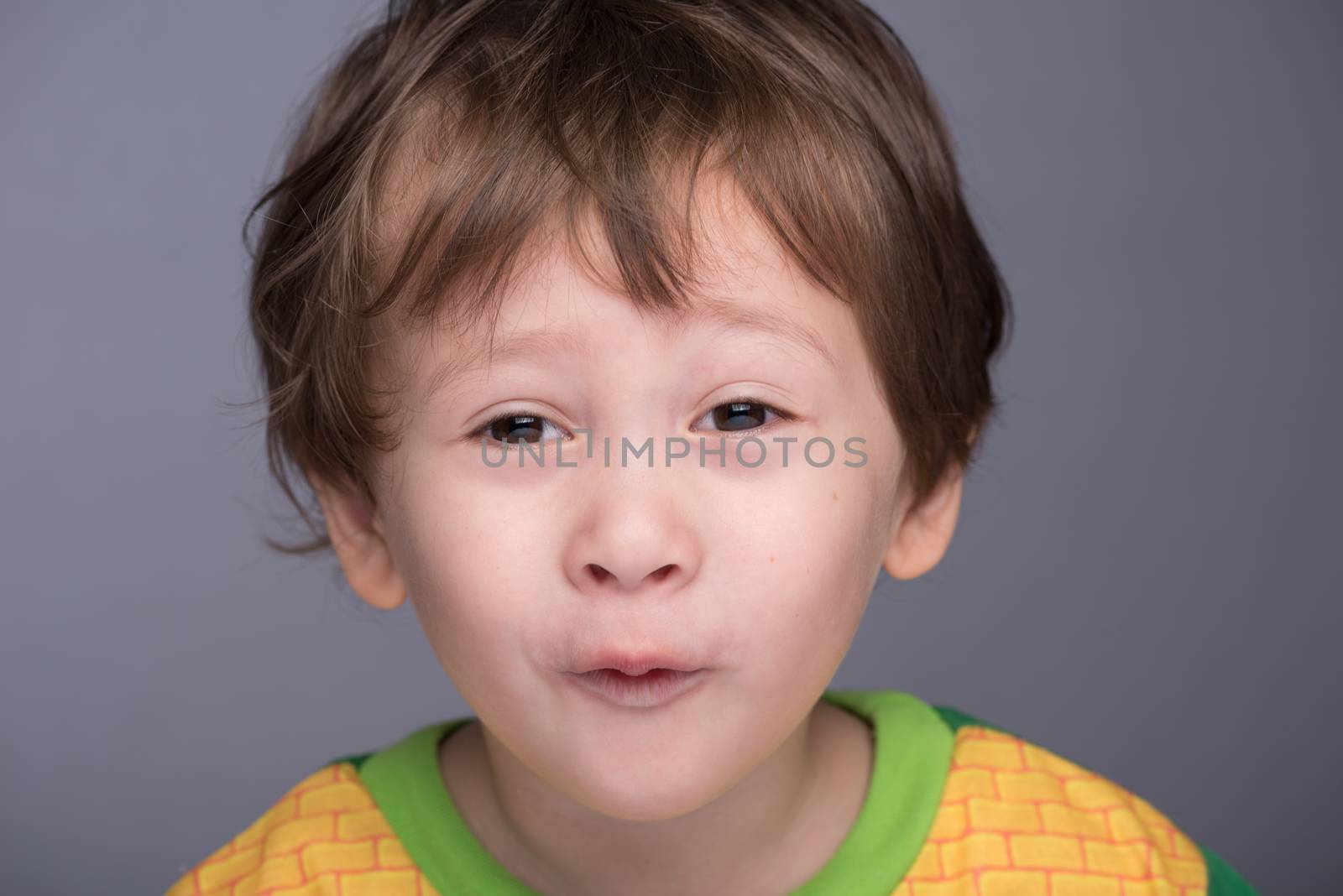 A happy 3 year old Japanese/Caucasian boy making a funny face.