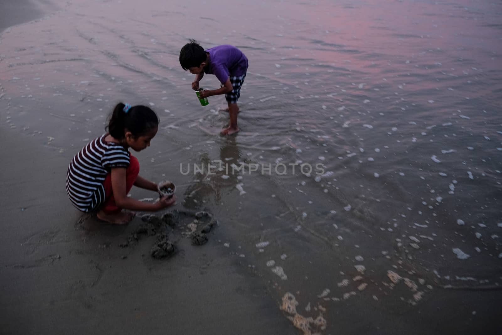 MALAYSIA - HAZE - CHILDREN PLAYING AT BEACH by newzulu