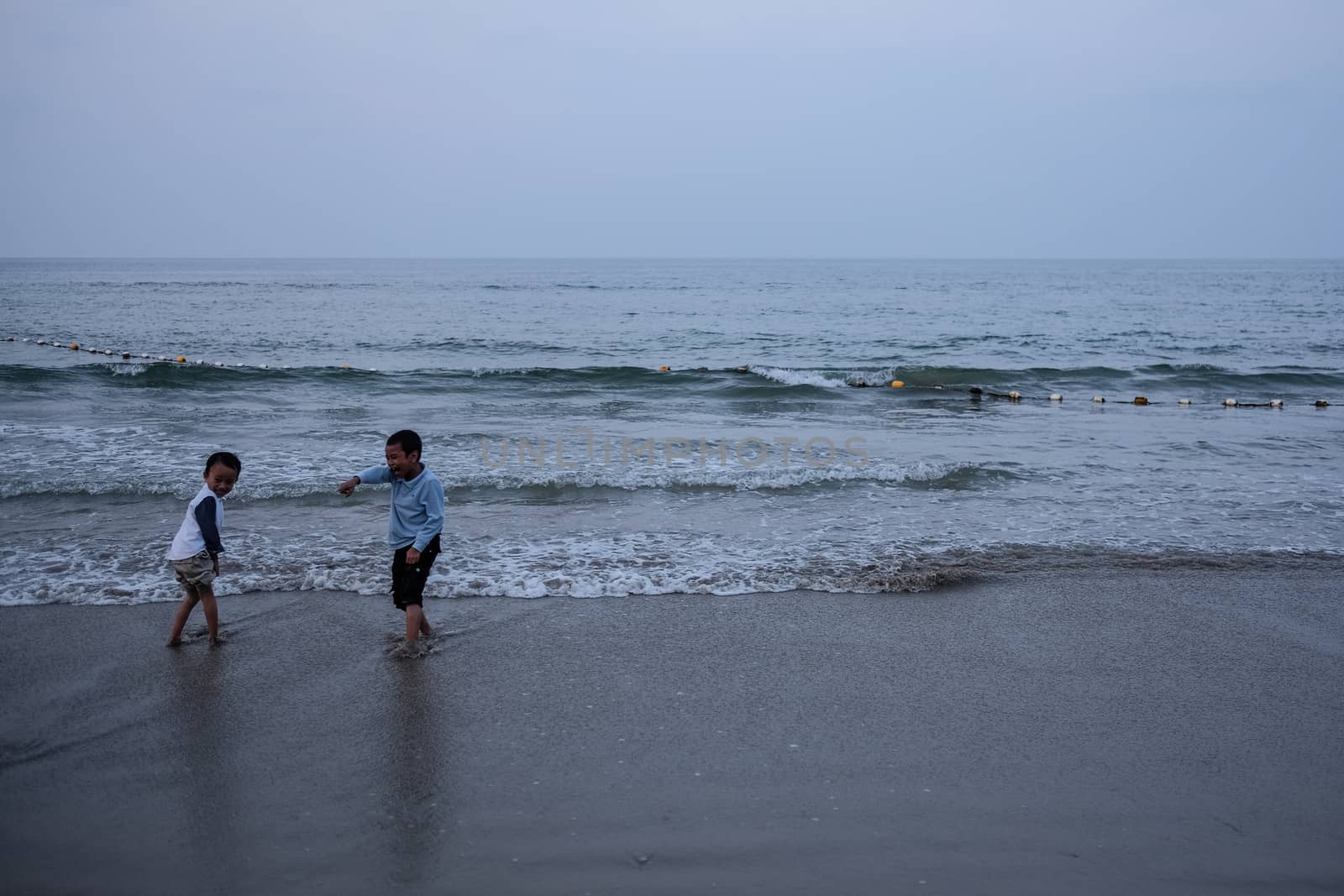 MALAYSIA - HAZE - CHILDREN PLAYING AT BEACH by newzulu