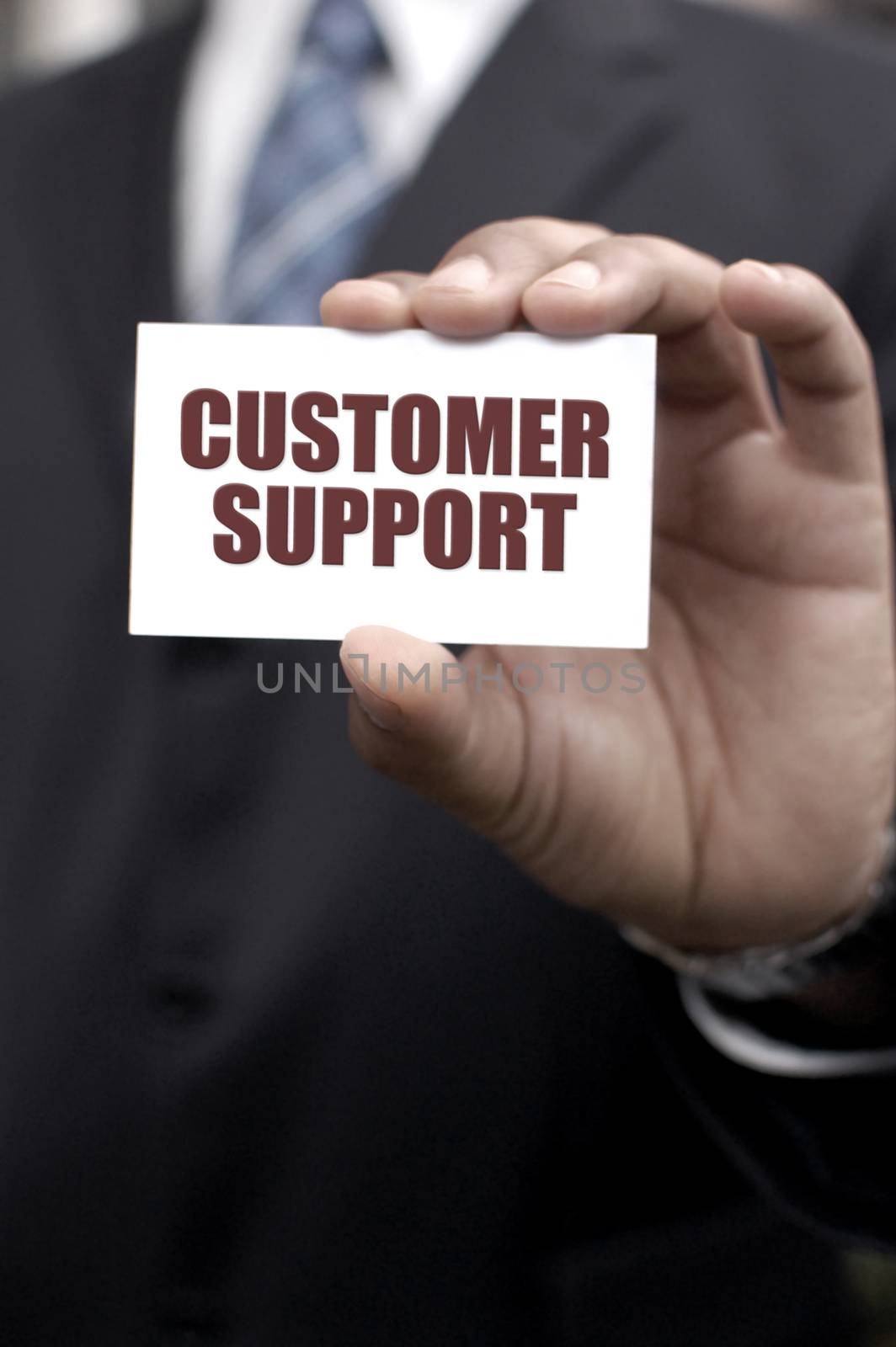 Business man holding out a card with customer support