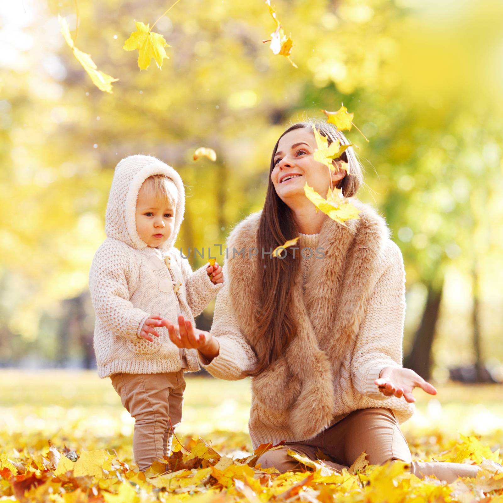 Mother and child in autumn park by Yellowj