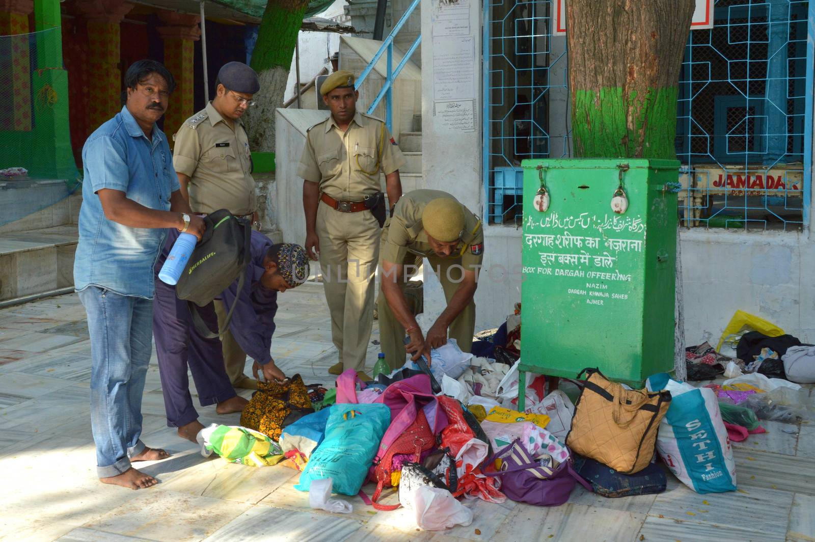 INDIA, Ajmer: Police search bags after a hoax bomb scare evacuated thousands of pilgrims from the Sufi shrine of Ajmer Sharif Dargah in Rajasthan on September 21, 2015.The call prompted security officials and bomb disposal crew to conduct a thorough search of the shrine, which lasted for more than an hour. After finding no suspected packages at the shrine, the call was determined to be a hoax. 