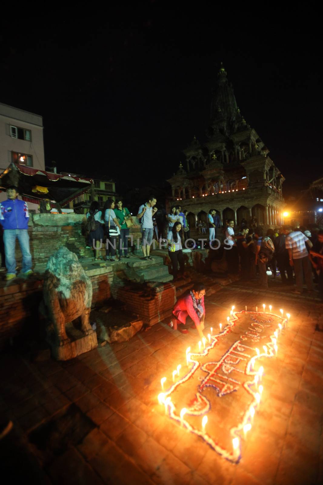 NEPAL, Kathmandu: Residents light candles at a celebration in Kathmandu, Nepal on September 21, 2015, one day after the government unveiled the country's first democratic constitution in a historic step. Out of the 598 members of the Constituent Assembly, 507 voted for the new constitution, 25 voted against, and 66 abstained in a vote on September 16, 2015. The event was marked with fireworks and festivities, but also with protests organized by parties of the Tharu and Madhesi ethnic communities.Photos taken by Newzulu contributor Dinesh Shrestha show the Nepalese people lighting candles to mark new chapter in the history of their country.