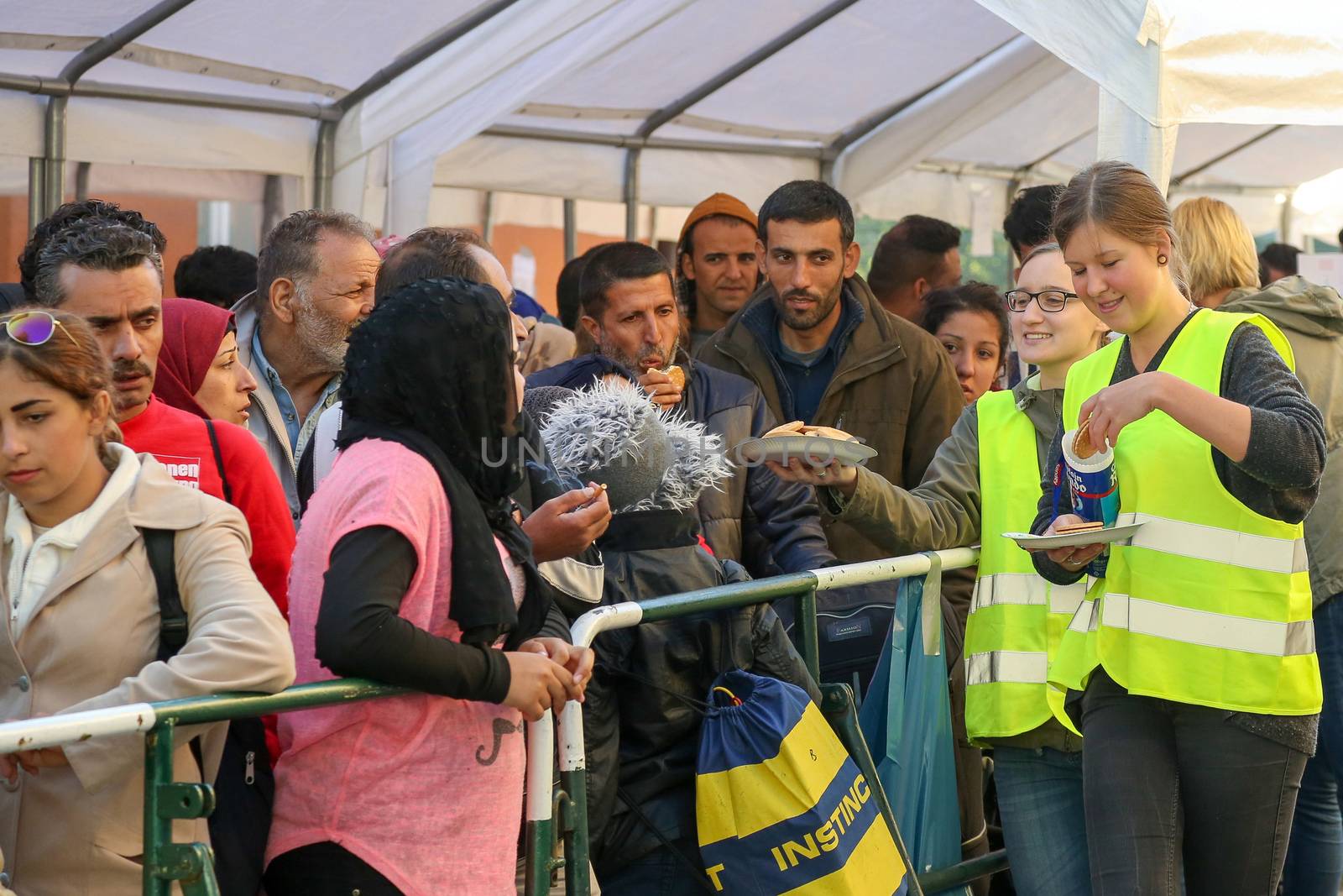  GERMANY, Passau: Volunteers tend to refugees standing in long queues in the border town of Passau, Germany on September 21, 2015 amid the reintroduction of border controls in Germany, Austria, and a number of other EU countries, aimed at slowing the flow of refugees from war-torn Syria.