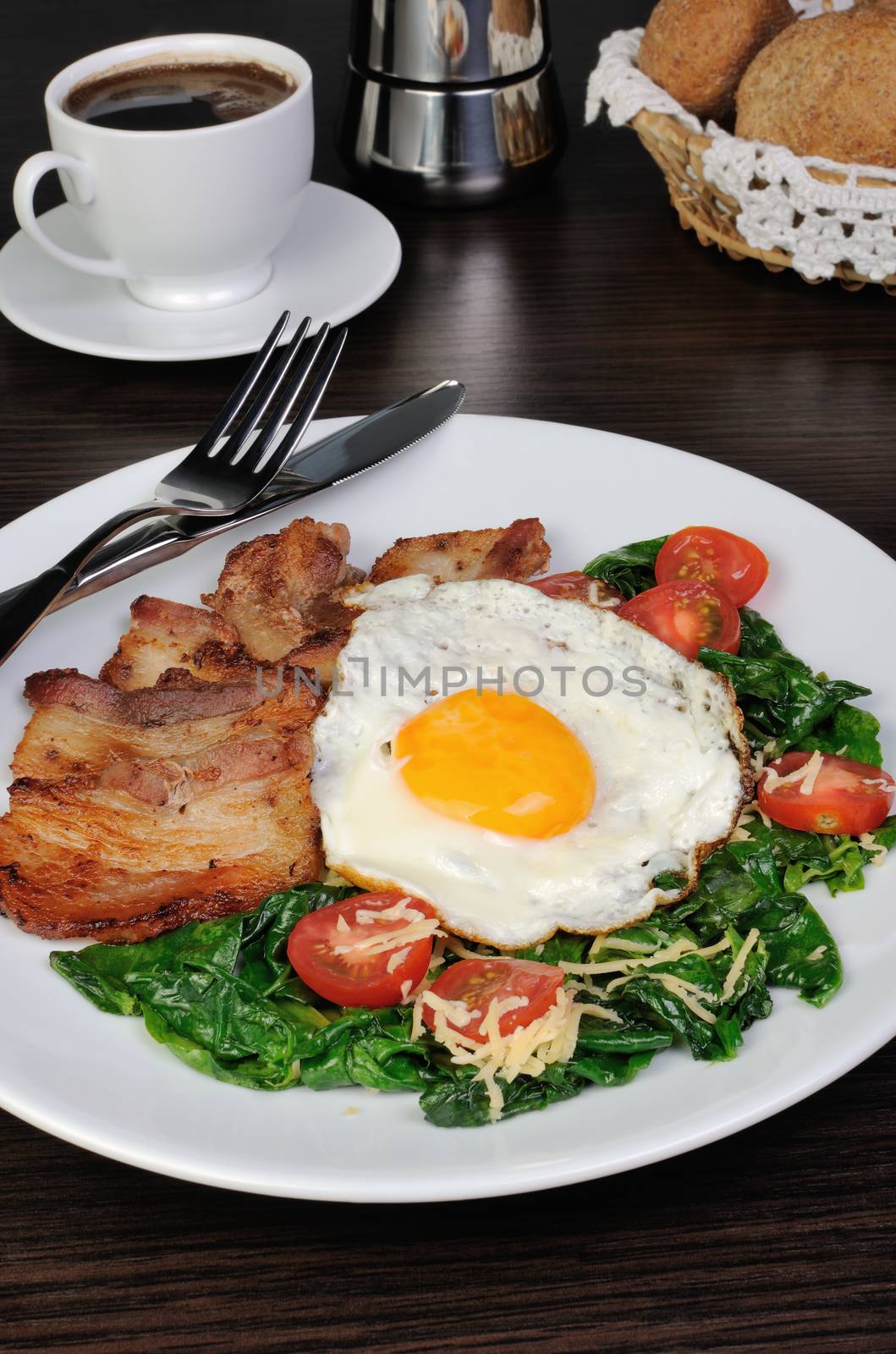 Scrambled eggs with bacon and spinach, cheese and cherry tomatoes