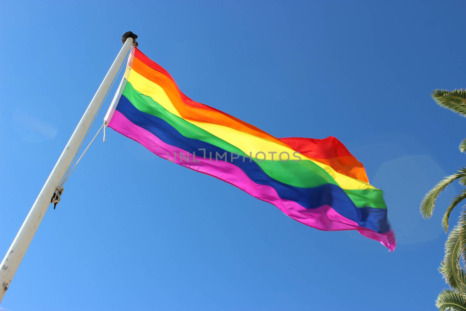 Rainbow Gay Pride Flag on Blue Sky Background. Nice, France