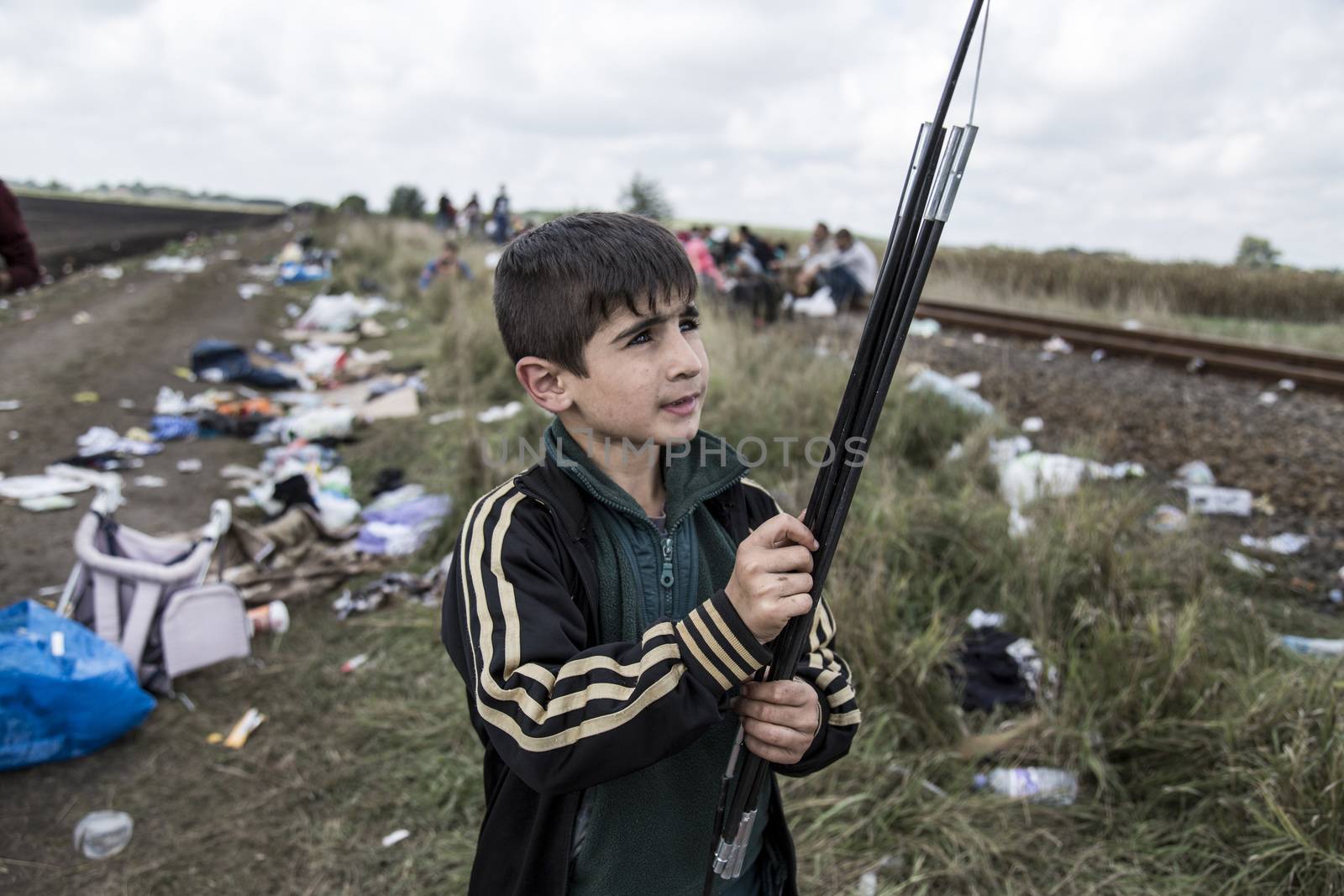 HUNGARY, Roszke: A boy helps his family to disassemble a tent  as the difficulties of living in Hungary's Roszke refugee camp is documented between September 8 and 12, 2015, as Europe's refugee crisis continues. 