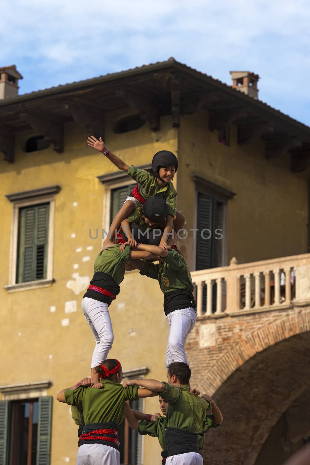 VERONA, ITALY - SEPTEMBER 19, 2015: Tocati, International festival of street games. Castells Performance of Xiquets d'Alcover of Tarragona, Catalonia, Spain. The Castells (Castle in Catalan) is a human tower - UNESCO intangible cultural heritage of humanity