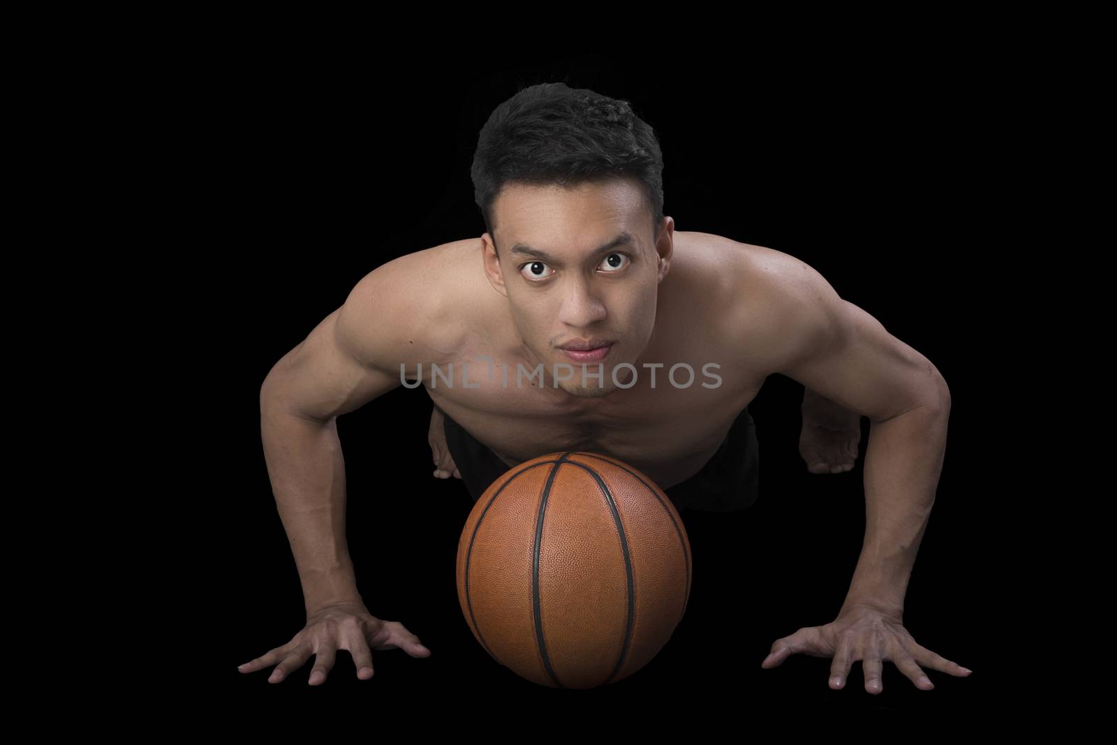 Asian young basketball player on black background