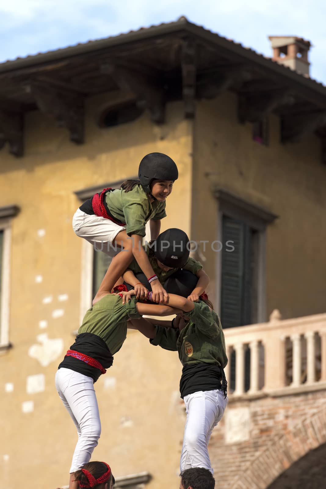 VERONA, ITALY - SEPTEMBER 19, 2015: Tocati, International festival of street games. Castells Performance of Xiquets d'Alcover of Tarragona, Catalonia, Spain. The Castells (Castle in Catalan) is a human tower - UNESCO intangible cultural heritage of humanity