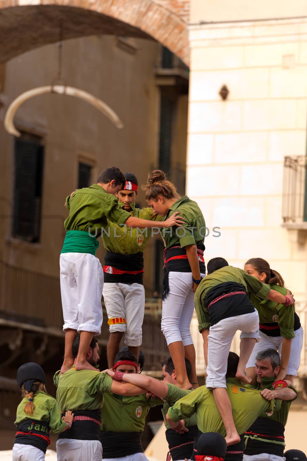 VERONA, ITALY - SEPTEMBER 19, 2015: Tocati, International festival of street games. Castells Performance of Xiquets d'Alcover of Tarragona, Catalonia, Spain. The Castells (Castle) is a human tower - UNESCO cultural heritage