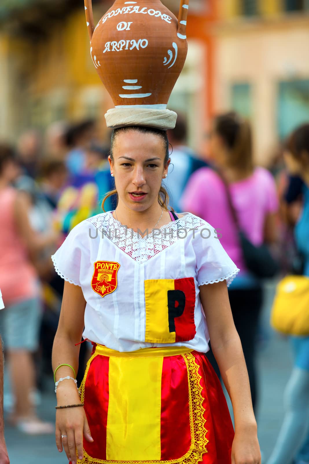 VERONA, ITALY - SEPTEMBER 19, 2015: Tocati, International festival of street games. Corsa con la Cannata - foot race with an expensive pitcher of water balanced on the head.