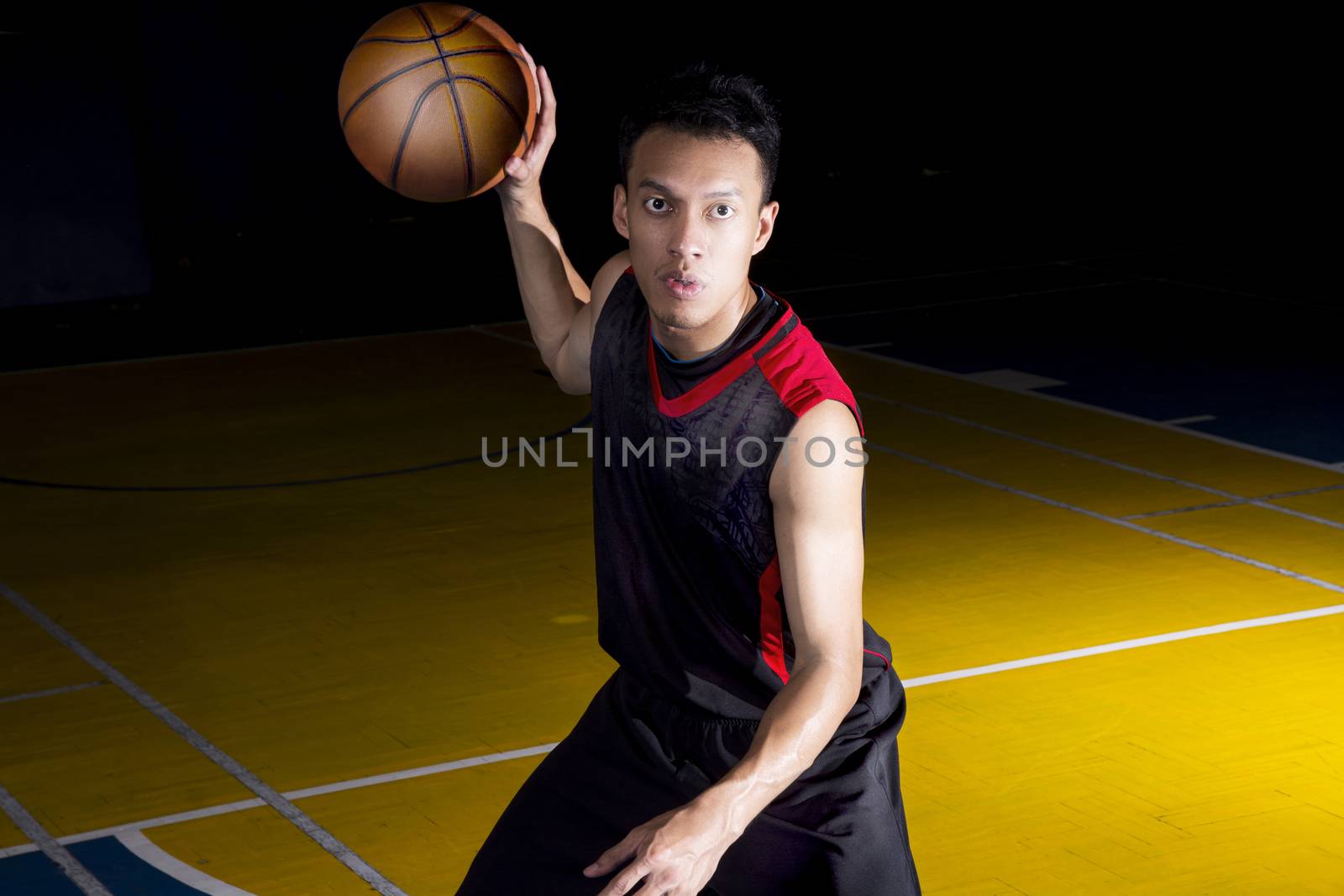 Asian young basketball player on basketball court