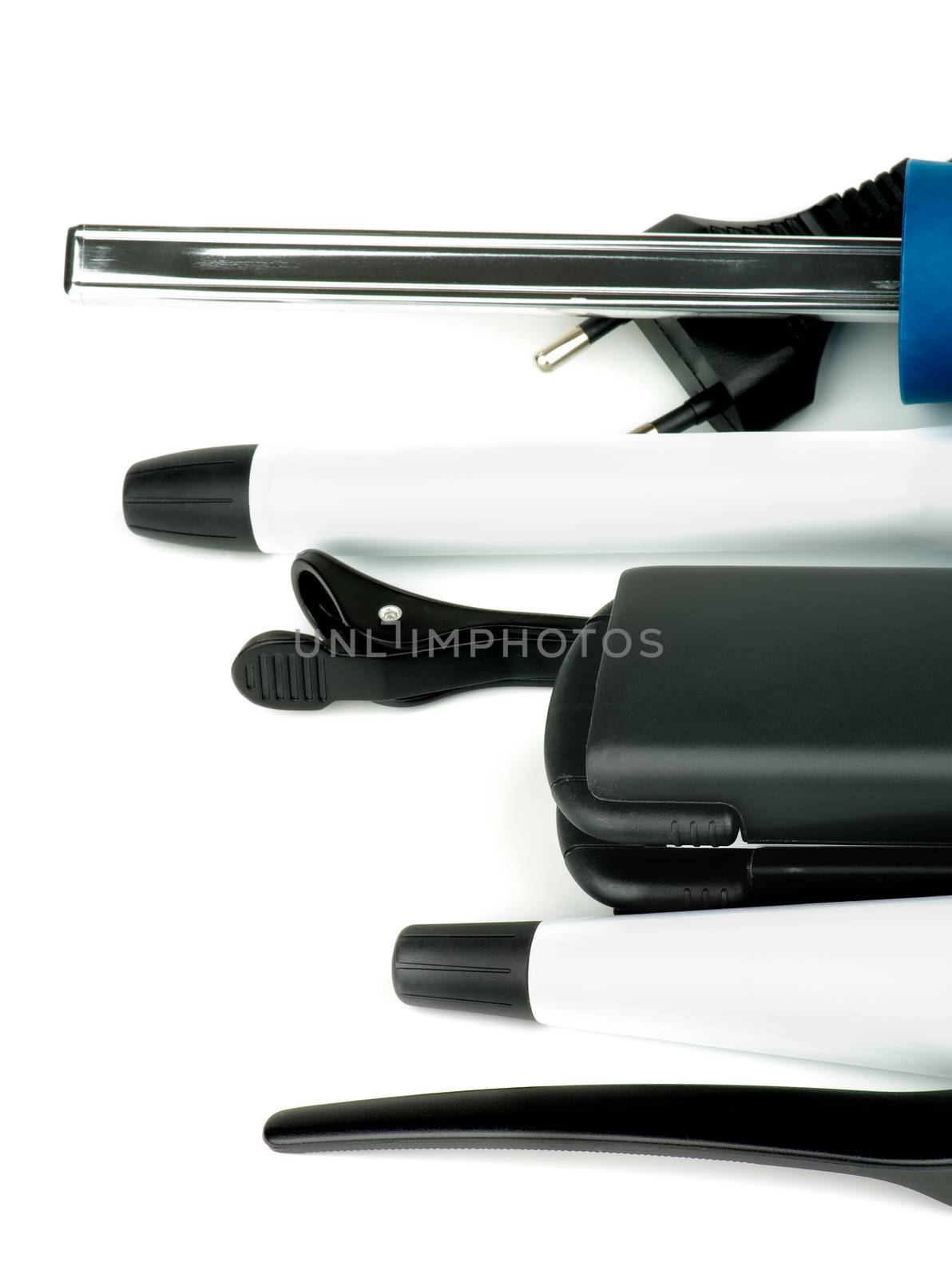 Arrangement of Black Comb and Various Hair Styling and Curling Equipment isolated on white background