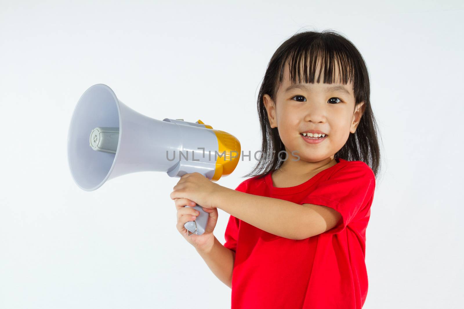 Portrait of a young little Chinese girl holding a megaphone in isolated white background.