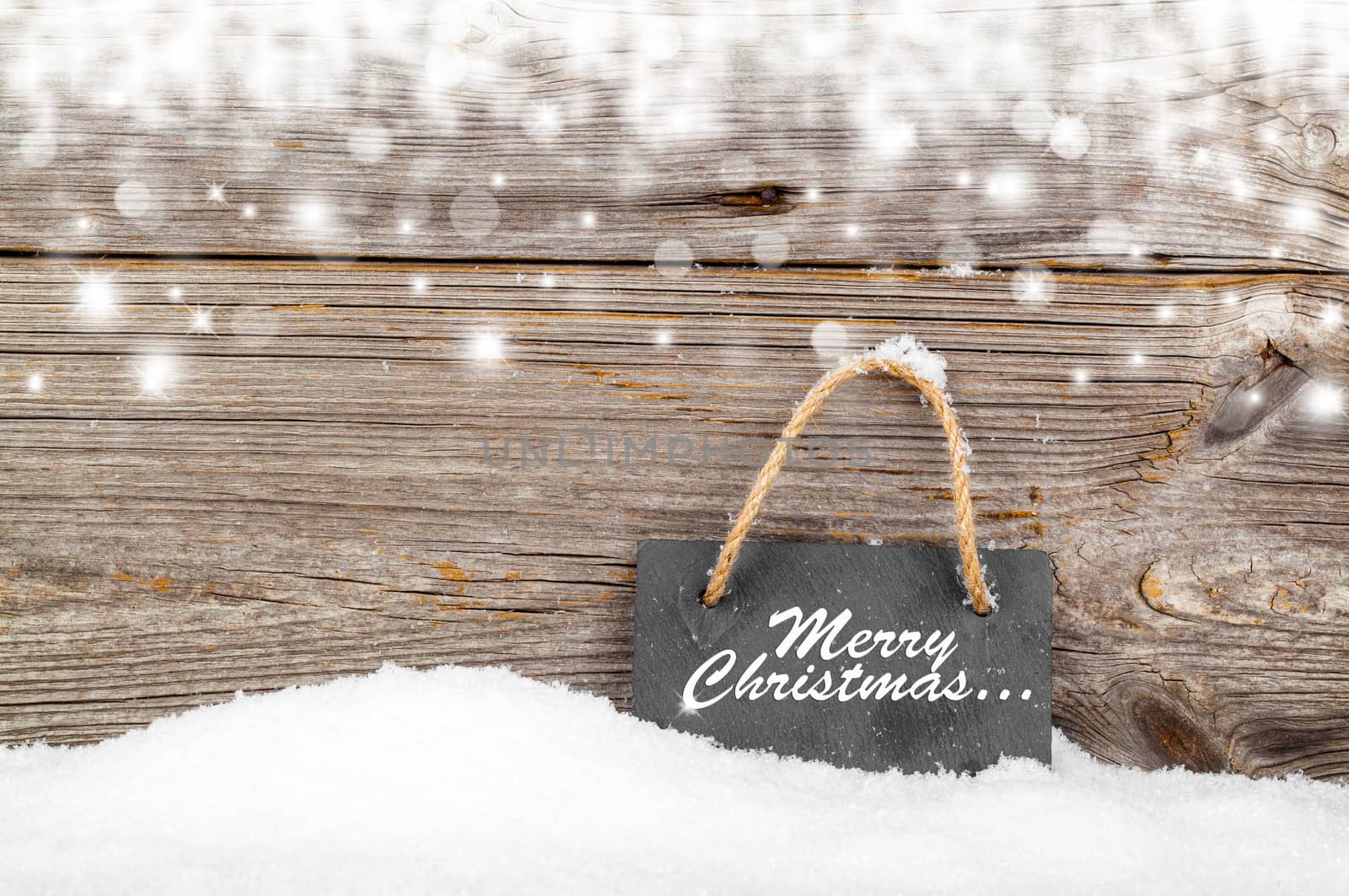 Black board of slate on old rustic wooden background, with snow by motorolka